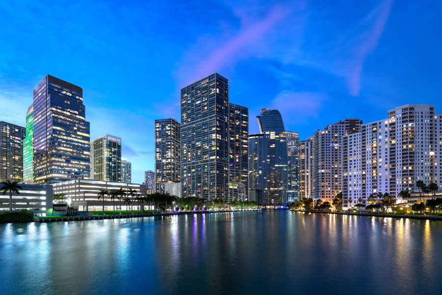 Street-level view of Brickell, a walkable Miami neighborhood filled with high-rise towers, restaurants, shops, and a constant flow of city life. Brickell City Centre anchors the neighborhood’s shopping and dining scene, blending modern design with Miami’s urban energy. 