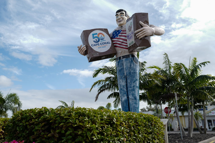 Big John, the oversized grocery clerk mascot statue in Cape Coral, Florida, located in the Town Center area and recognized as a longtime local landmark reflecting the city’s community character and history.