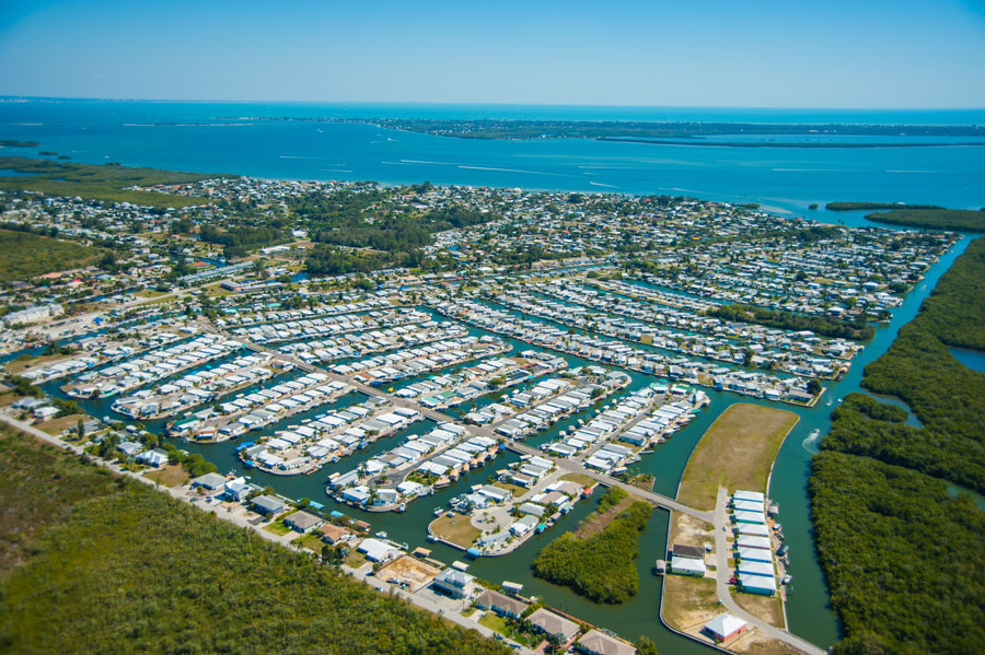 Aerial view of Pine Island, Florida, showing waterfront communities, canals, and surrounding mangrove estuaries along the Gulf Coast in Lee County. Pine Island is known for its laid-back atmosphere, boating access, and strong connection to Southwest Florida’s fishing waters.