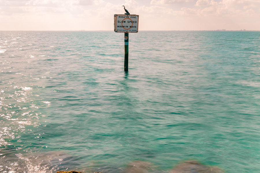 Manatee zone marker in the waters surrounding Virginia Key, highlighting protected marine areas and boating speed restrictions in Biscayne Bay.