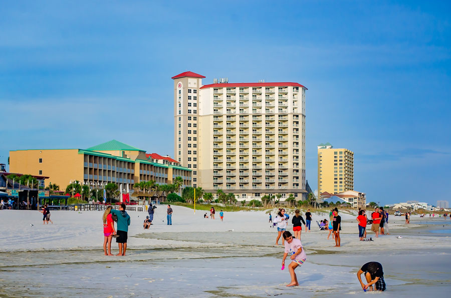 Visitors enjoy the white-sand shoreline of Pensacola Beach on Santa Rosa Island in Northwest Florida. Located just across the bay from Pensacola, the barrier island community combines Gulf beaches with fishing, boating, restaurants and easy access to the protected coastal landscapes of Gulf Islands National Seashore.
