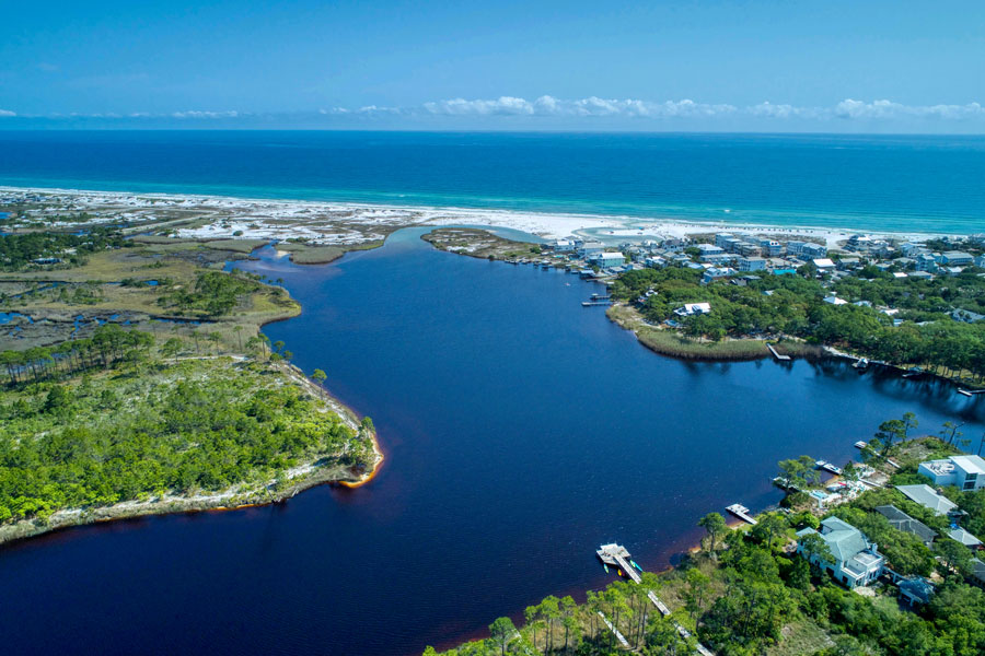 An aerial view of Grayton Beach highlights Western Lake, one of South Walton’s distinctive coastal dune lakes, separated from the Gulf of Mexico by a narrow band of white sand and dunes. These unusual lakes are an important part of the Emerald Coast landscape and provide opportunities for paddling, fishing and wildlife viewing near Grayton Beach State Park.