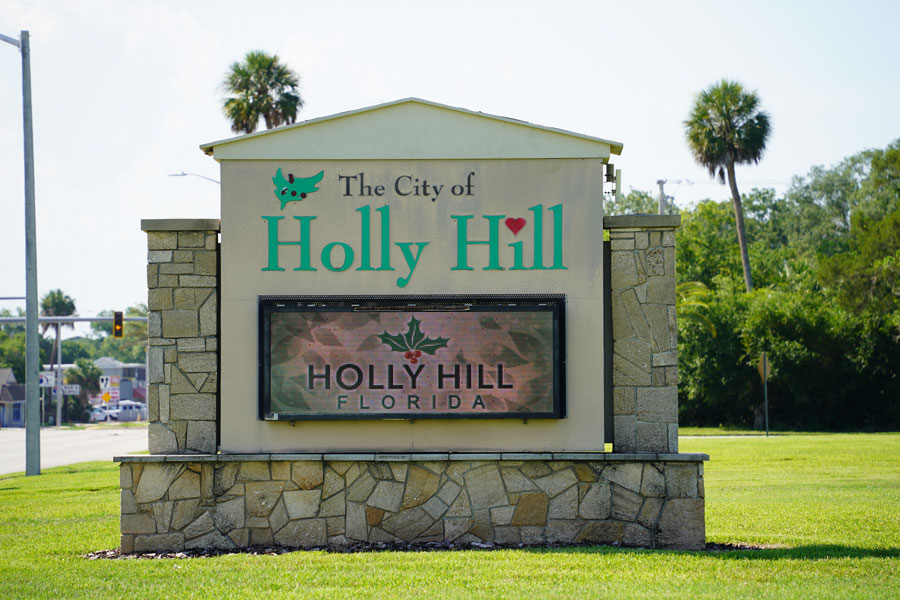 A City of Holly Hill welcome sign marks the community in Volusia County, Florida, where palm trees and a subtropical landscape reflect its setting along the Halifax River between Daytona Beach and Ormond Beach.