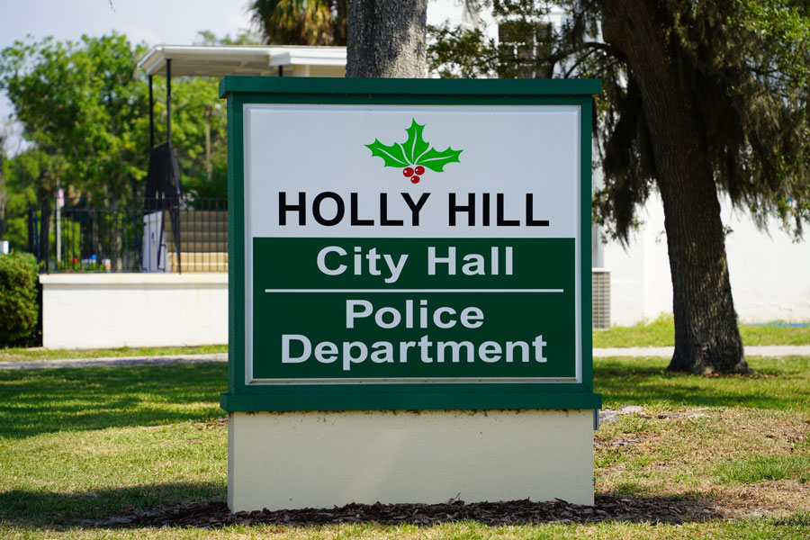 A sign identifies Holly Hill City Hall and the Holly Hill Police Department, two of the municipal facilities serving residents of this Volusia County community. The civic complex is located near the heart of Holly Hill, just west of the Halifax River. 