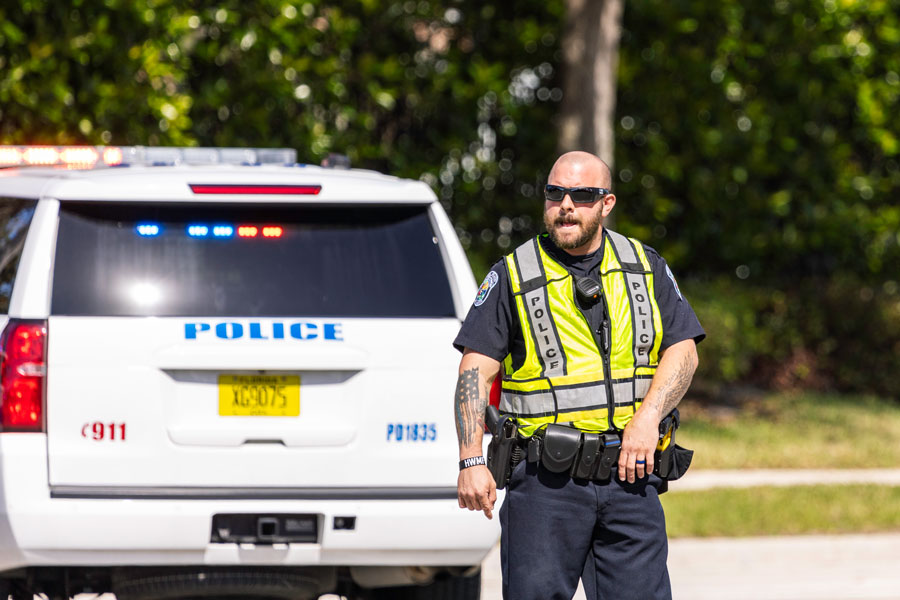 A Riviera Beach police officer works at the scene of a traffic accident along Congress Avenue in Riviera Beach, Florida, on February 20, 2021. Photo credit: Joe Ciciless; licensed.