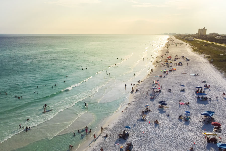 An aerial view of the Gulf Coast near Miramar Beach in South Walton, where visitors swim, paddle and relax along miles of sugar-white sand and turquoise water. The expansive shoreline and clear Gulf waters showcase the coastal scenery that makes this part of Northwest Florida a popular beach destination.