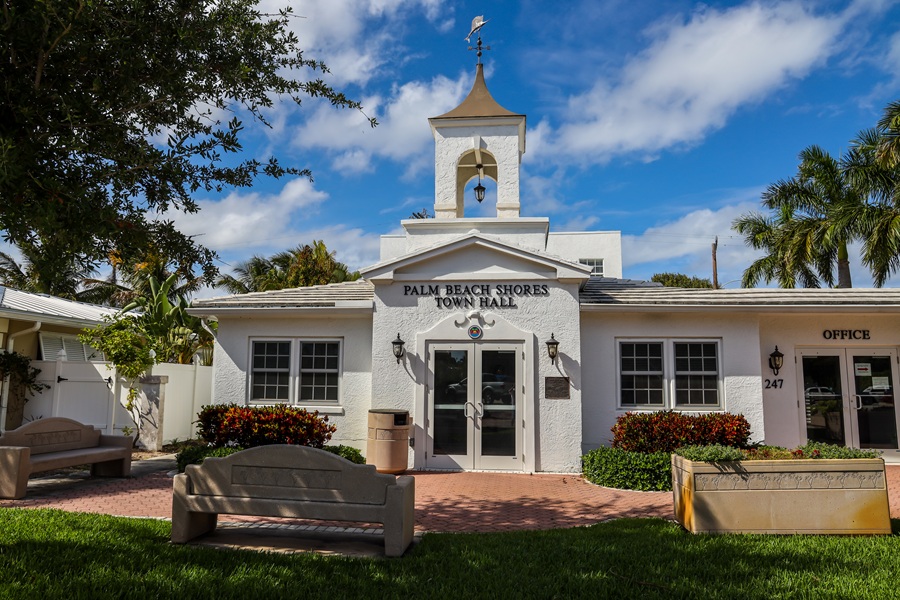 Palm Beach Shores Town Hall serves as the municipal center of the small coastal community at the southern end of Singer Island. Palm trees, landscaped grounds, and the building’s distinctive bell tower reflect the town’s intimate South Florida setting. Photo credit: Leonard Zhukovsky; licensed.