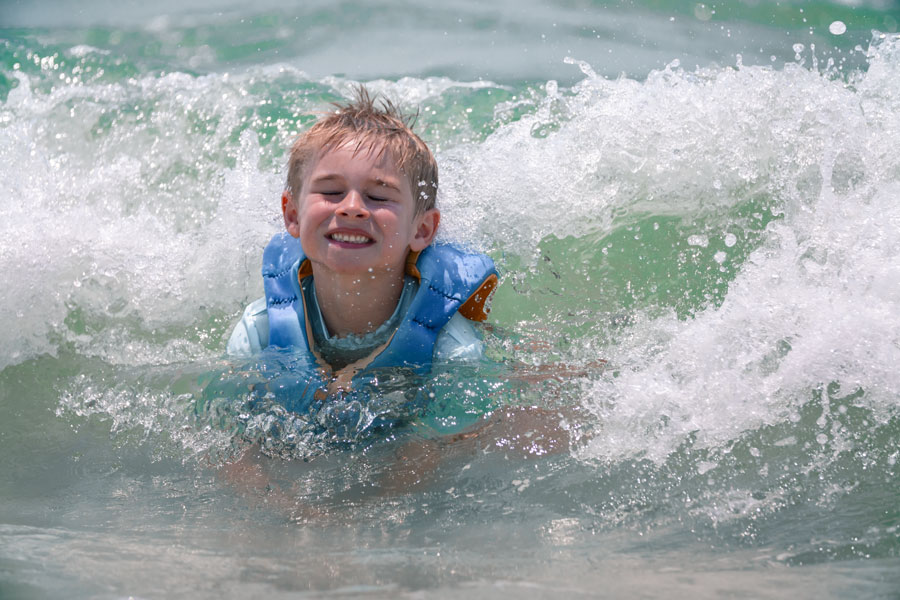 A young visitor enjoys the emerald-green Gulf waters at Mexico Beach along Florida’s Panhandle. Family beach days are a major part of the coastal experience, with swimming, playing in the surf and exploring miles of white-sand shoreline among the region’s most popular activities. Photo credit: J. Frederick; licensed.