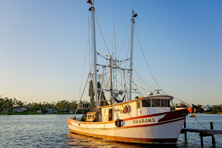 A traditional shrimp boat rests at a dock in Panama City, reflecting the commercial fishing and seafood industries that have long been part of life along Florida’s Panhandle. Working waterfronts, fishing vessels and local seafood remain an important part of the region’s maritime character alongside its beaches and recreational boating.