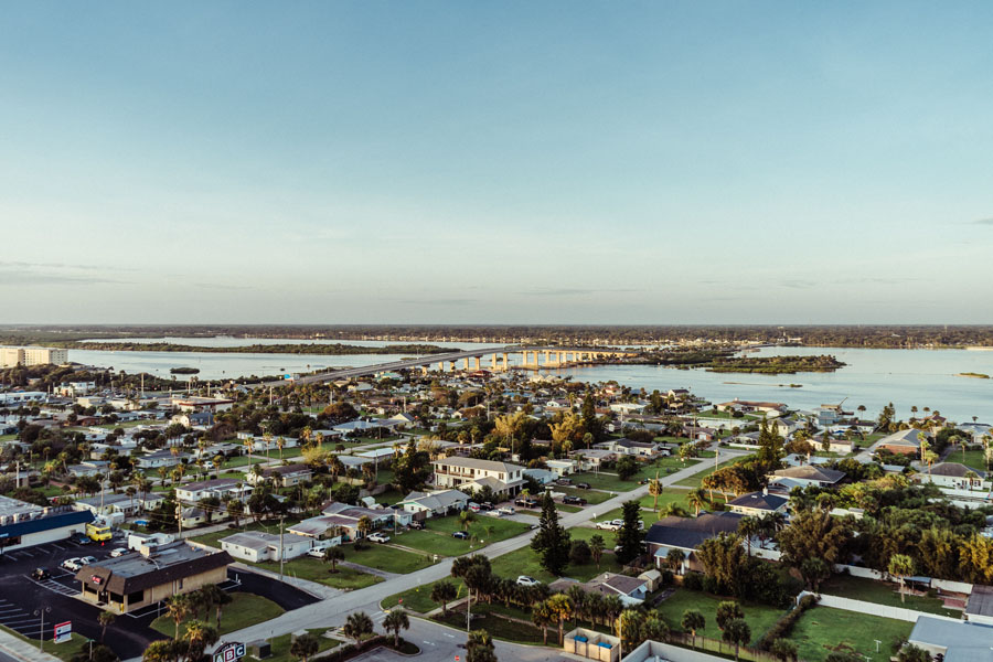 An aerial view over the Halifax River near Daytona Beach Shores shows the broad Intracoastal Waterway, surrounding residential neighborhoods, and a bridge connecting the mainland with Volusia County’s barrier island communities. The Halifax River is a major feature of the Daytona Beach area and forms part of the Intracoastal Waterway system that extends along Florida’s Atlantic coast. Its sheltered waters support boating, fishing, waterfront recreation, and access to communities including Daytona Beach, Port Orange, and Ponce Inlet. Photo credit: Dustin Romeiro; licensed.
