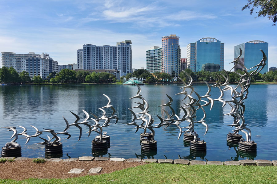 EQRoy
A view of downtown Orlando's skyline across Lake Eola, featuring the distinctive Take Flight sculpture of stainless-steel birds rising above the waterfront at Lake Eola Park. Located in the heart of downtown Orlando, the park is a popular gathering place known for its scenic walking paths, swan boats, public art and views of the city's growing skyline. Photo credit: EQRoy, licensed.